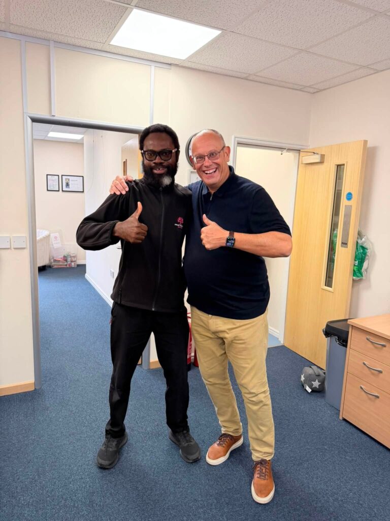 AshwellCare manager and staff smiling with thumbs up in office